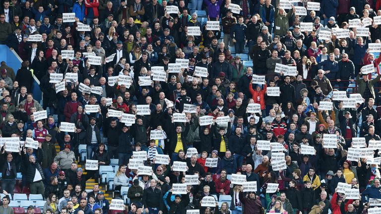 Aston Villa supporters hold protesting banners