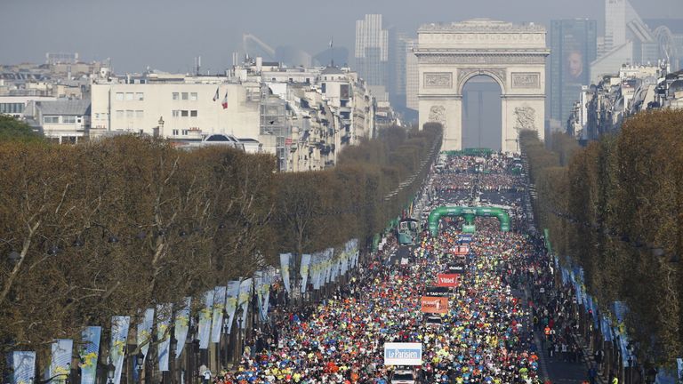 Competitors in the Paris Marathon run down the iconic Champs-Elysees