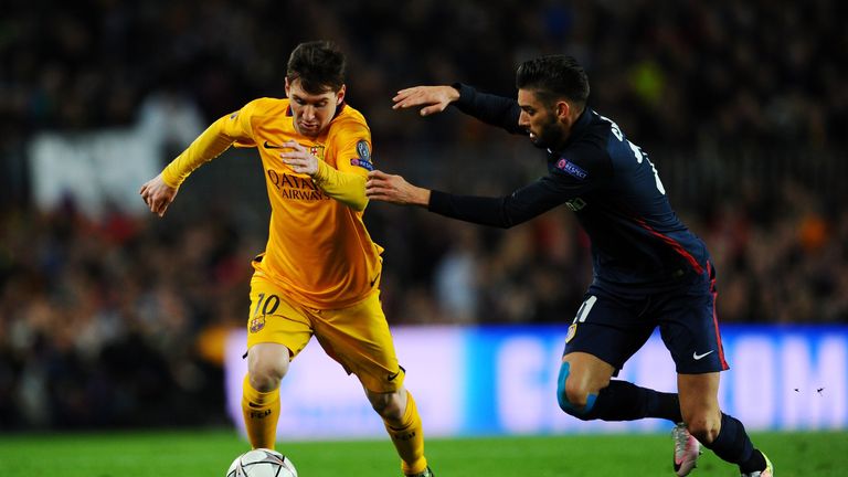 Lionel Messi of Barcelona is chased by Yannick Carrasco of Atletico Madrid