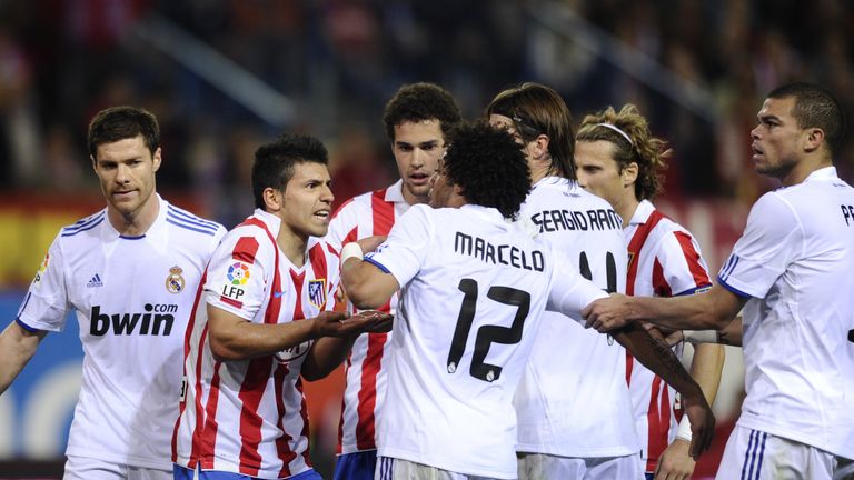 Atletico Madrid's Sergio Aguero argues with Real Madrid's Marcelo as Pepe and Xabi Alonso look on in March 2011