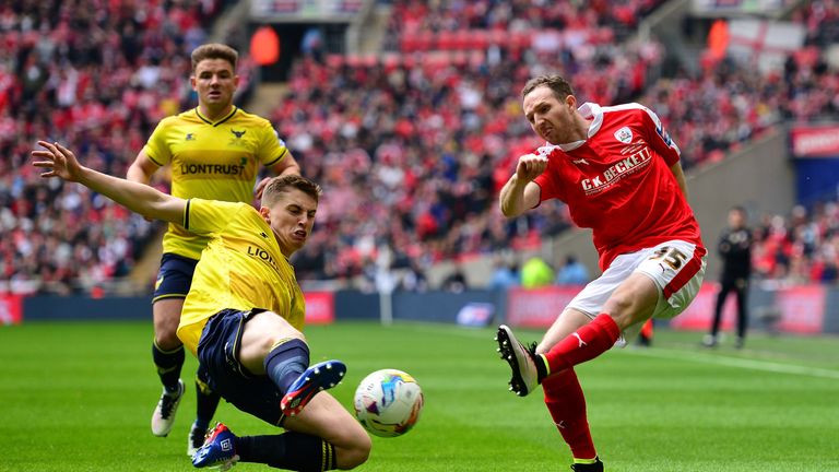 Aidan White of Barnsley has his cross blocked by Jonjoe Kenny of Oxford United during the Johnstone's Paint Trophy Final betwe
