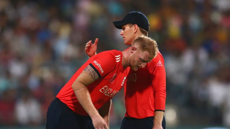 Eoin Morgan speaks with Ben Stokes of England as he bowled the last over 