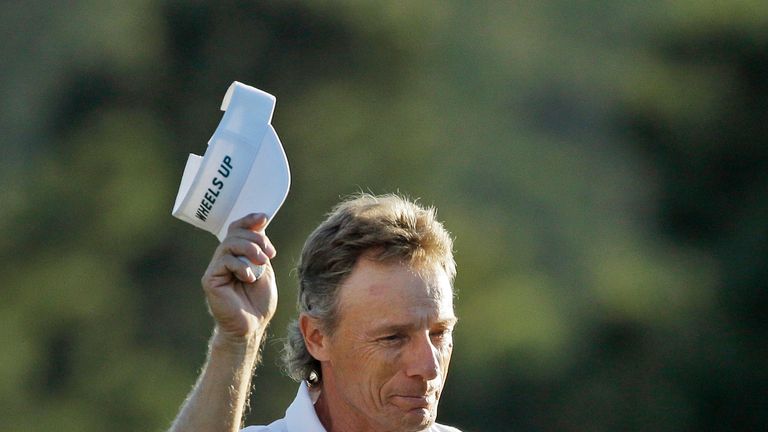 Bernhard Langer tips his cap after putting out on the 18th green