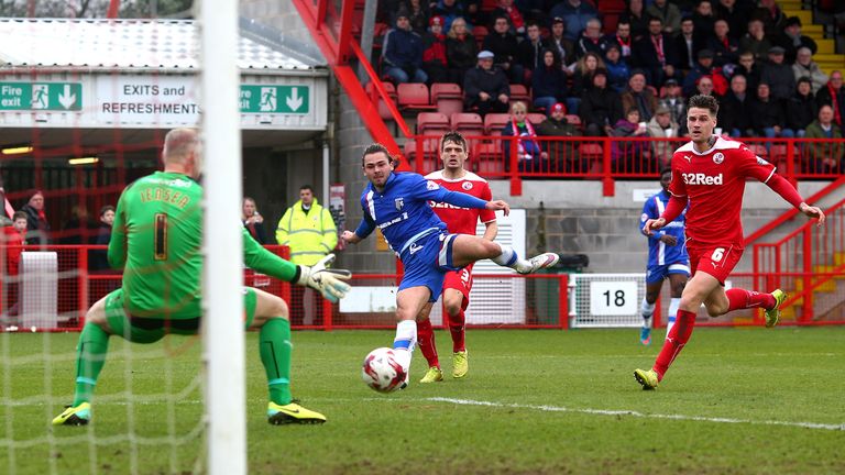 Bradley Dack (C) of Gillingham scores the first goal of the game against Crawley Town