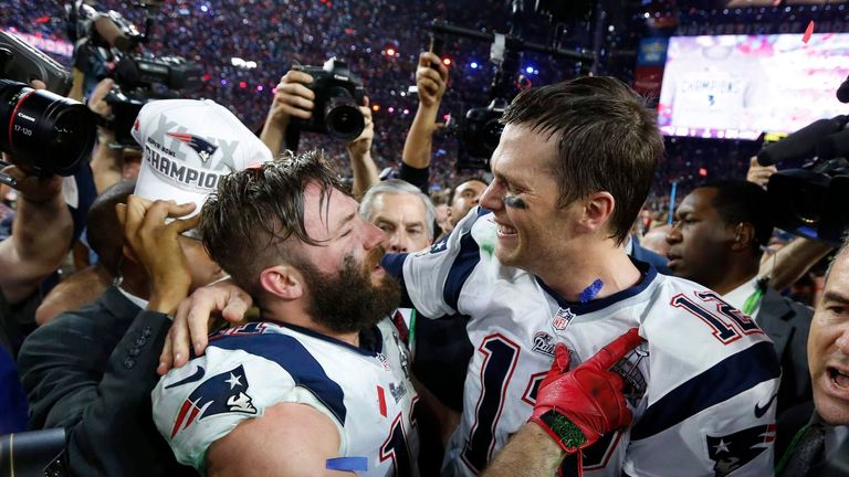 New England Patriots quarterback Brady is embraced by wide receiver Edelman after their team defeated the Seattle Seahawks in the NFL Super Bowl XLIX football game in Glendale