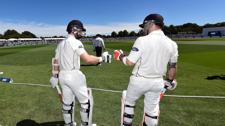 Brendon McCullum (R) captain of New Zealand walks out onto the field for New Zealand for the last time after lunch with team-mate Kane Williamson