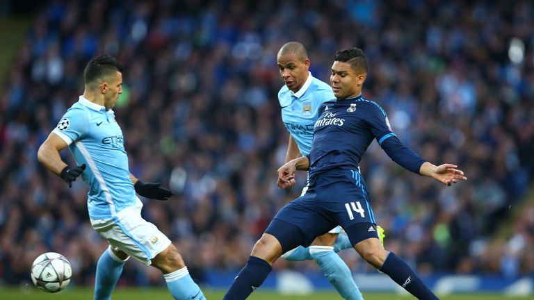 Casemiro of Real Madrid CF is closed down by Sergio Aguero of Manchester City