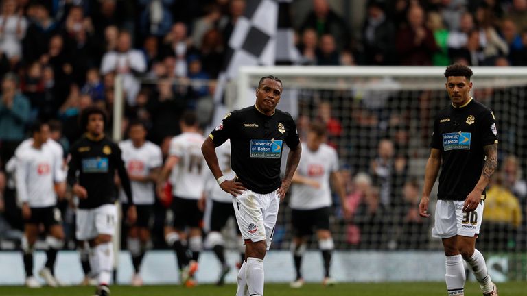 Dejected Bolton players as Derby celebrate their second goal in their 4-1 win