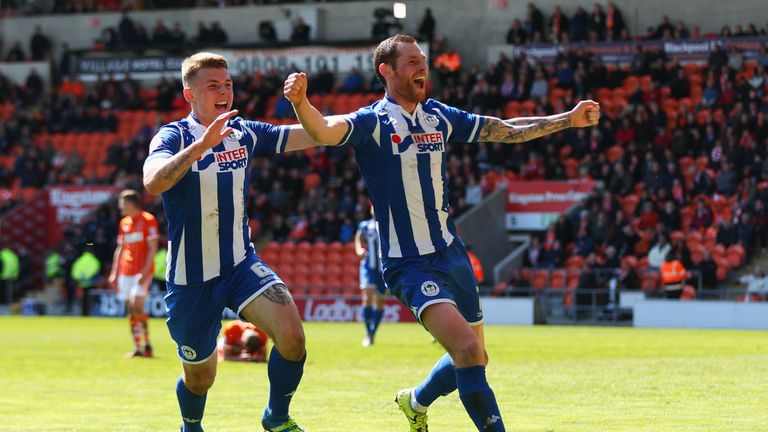 Chris McCann of Wigan Athletic (R) celebrates with Max Power (L) as he scores their first goal in 4-0 win over Blackpool