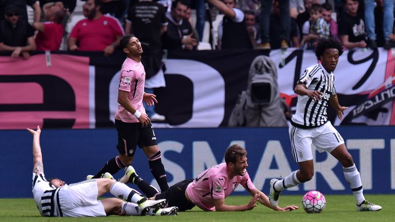 Claudio Marchisio (L) of Juventus and Franco Vazquez of Palermo lie on the pitch after an injury 