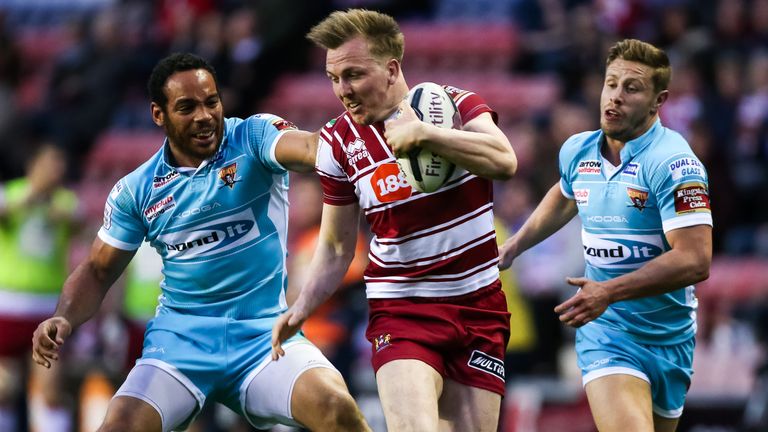 Dan Sarginson is tackled by Huddersfield's Leroy Cudjoe.