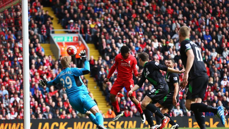 Daniel Sturridge of Liverpool (2L) scores their second goal with a header past goalkeeper Jakob Haugaard of Stoke