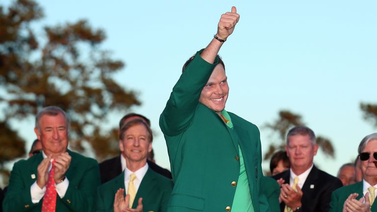 Danny Willett of England reacts after being presented with the green jacket for winning the final round of the 2016 Masters 
