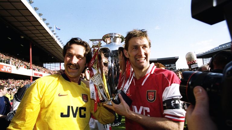 David Seaman of Arsenal and club captain Tony Adams hold the championship trophy after the FA Carling Premiership match against Everton at Hig