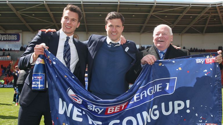 Wigan Athletic chairman David Sharpe, manager Gary Caldwell and owner Dave Whelan celebrate promotion