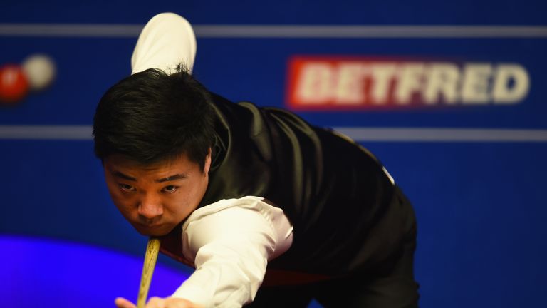 Ding Junhui in action during his match against Judd Trump during the World Snooker Championship