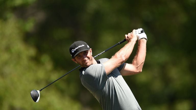 Dustin Johnson of the United States watches his tee shot on the second hole during the final round of the Shell Houston Open at the