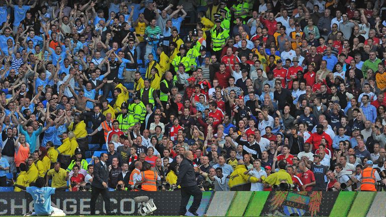 Emmanuel Adebayor celebrates in front of the Arsenal fans after scoring for Manchester City