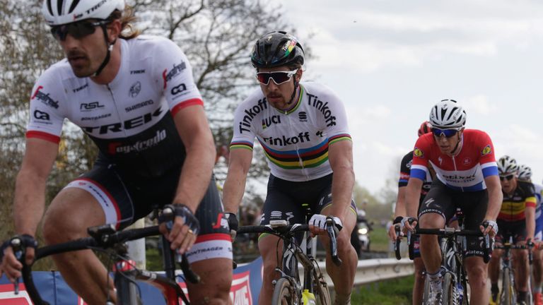 Fabian Cancellara (L) rides ahead of Peter Sagan (2ndL) and Niki Terpstra on the cobblestones during the 114th edition of the Paris-Roubaix 