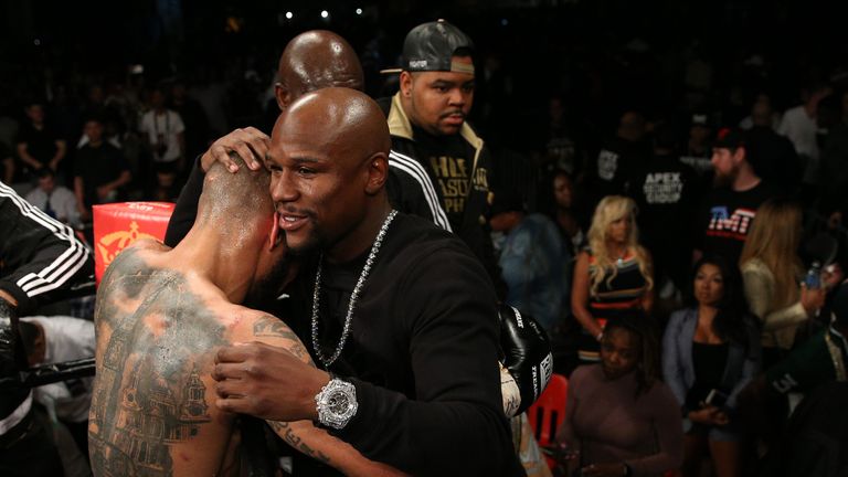 Ashley Theophane (L) is consoled by Floyd Mayweather 