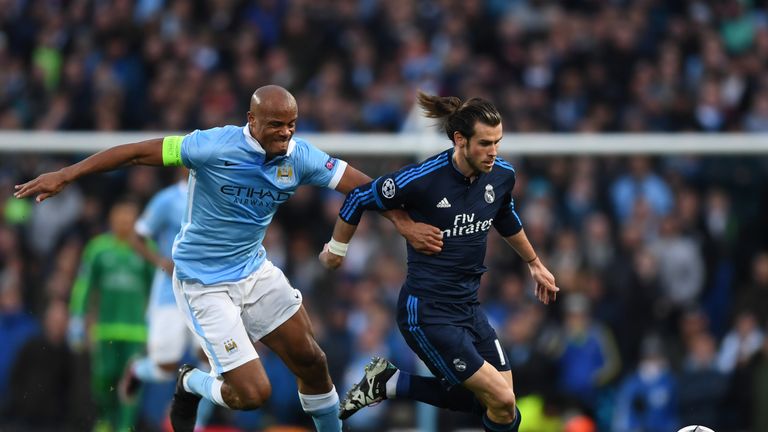 Gareth Bale of Real Madrid CF is challenged by Vincent Kompany of Manchester City during the UEFA Champions League Semi Final