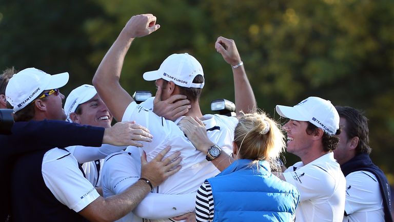 MEDINAH, IL - SEPTEMBER 30:  Martin Kaymer of Europe is congratulated after making the putt that retained the Ryder Cup on the the 18th green in his match 