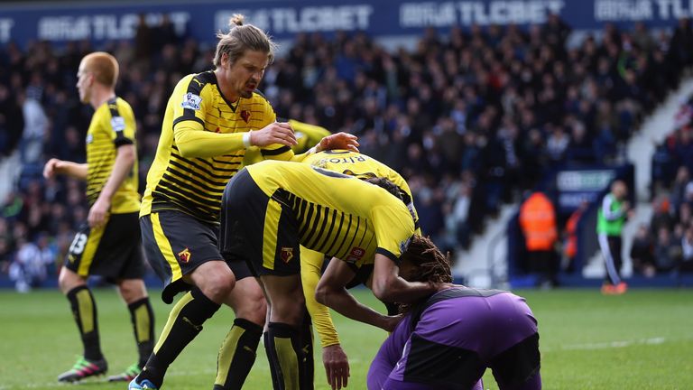 Watford's Heurelho Gomes is congratulated by team-mates after saving a second Saido Berahino penalty