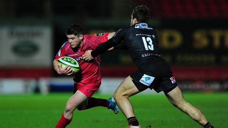 Harry Robinson of Scarlets is tackled by Tom Fowlie of London Irish during an LV= Cup match in January 2015.