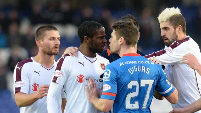 Hearts' Arnaud Djoum (left) shares a difference of opinion with Iain Vigurs of Inverness