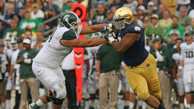 Stephon Tuitt #7 of the Notre Dame Fighting Irish rushes against Jack Conklin #74 of the Michigan State Spartans at Notre D