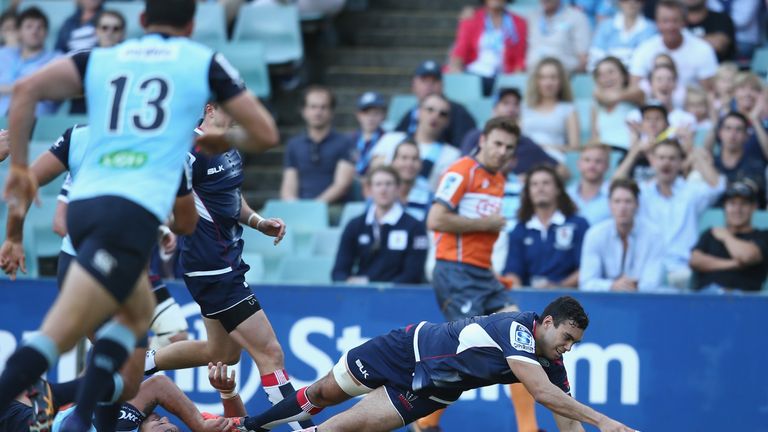 Jack Debreczeni of the Rebels scores a try against the NSW Waratahs 