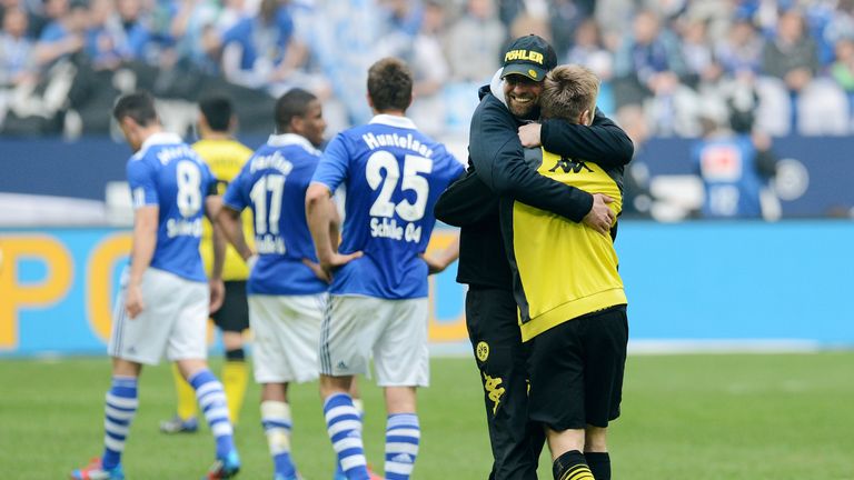 Borussia Dortmund head coach Jurgen Klopp hugs midfielder Jakub Blaszczykowski after the Bundesliga win over Schalke in 2012