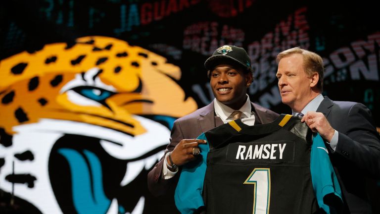 Jalen Ramsey of the Florida State Seminoles holds up a jersey with NFL Commissioner Roger Goodell after being picked #5 over
