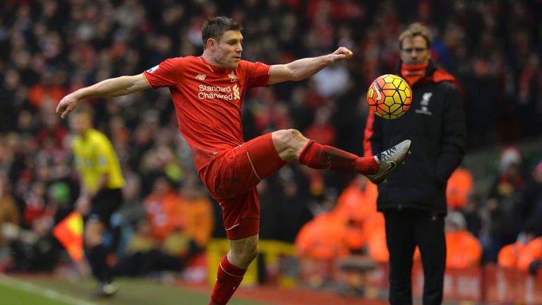 James Milner tries to keep the ball in play in front of Liverpool manager Jurgen Klopp