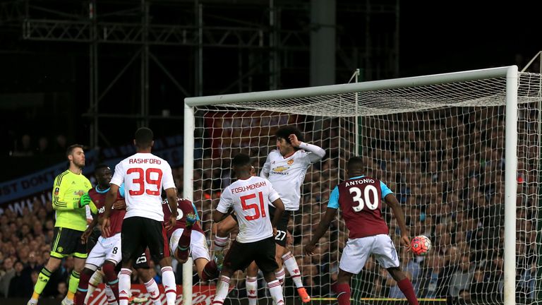 West Ham United's James Tomkins (centre) scores his side's first goal of the game during the Emirates FA Cup, Quarter Final Replay match at Upton Park, Lon