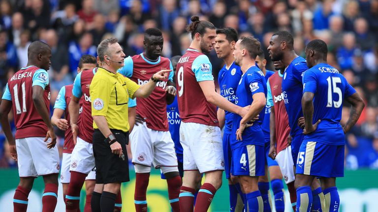 Match referee Jonathan Moss awards a penalty to Leicester City after a foul by West Ham's Andy Carroll (centre) during the Premier League match