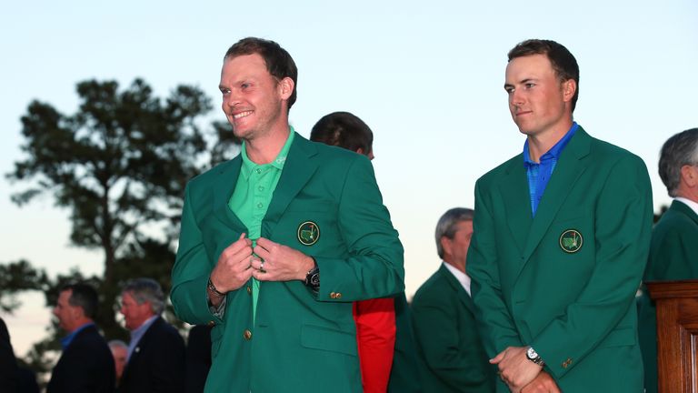 Jordan Spieth of the United States presents Danny Willett of England with the green jacket after Willett won the final round 