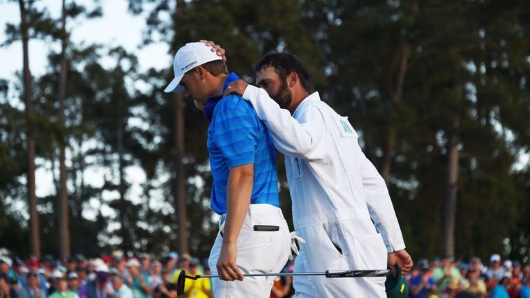 Jordan Spieth is comforted by his caddie Michael Greller as they leave the 18th green