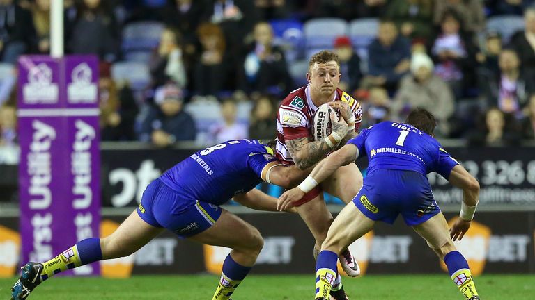 Josh Charnley is tackled by Chris Hill (left) and Kurt Gidley (right)