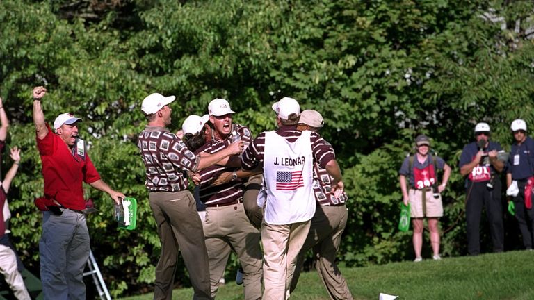 26 Sep 1999:  Justin Leonard of the USA is mobbed by the American team after sinking a long birdie putt on the 17th during the final day of the 33rd Ryder 