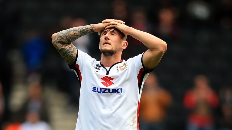 Kyle McFadzean looks dejected after MK Dons were relegated with defeat to Brentford