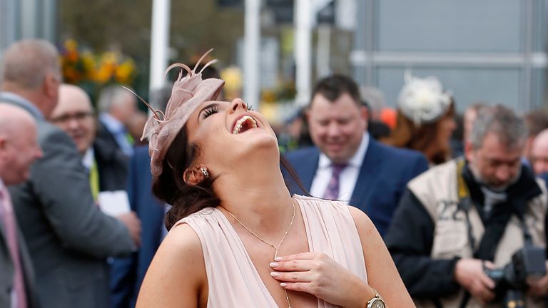 A female racegoer has a laugh during Ladies Day of the Crabbie's Grand National Festival