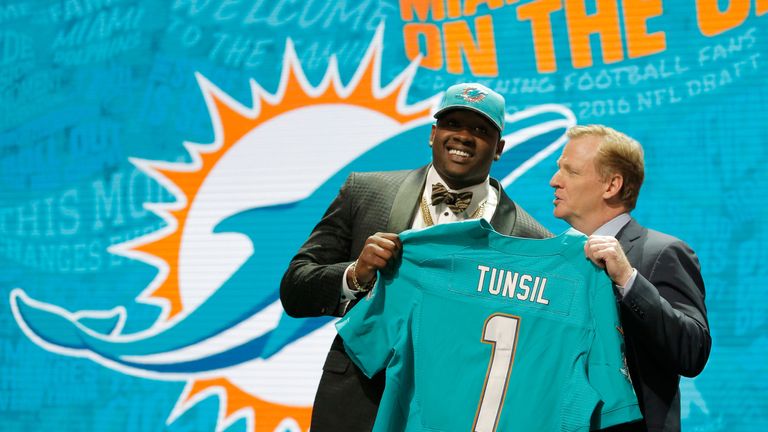 CHICAGO, IL - APRIL 28:  (L-R) Laremy Tunsil of Ole Miss holds up a jersey with NFL Commissioner Roger Goodell after being picked #13 overall by the Miami 
