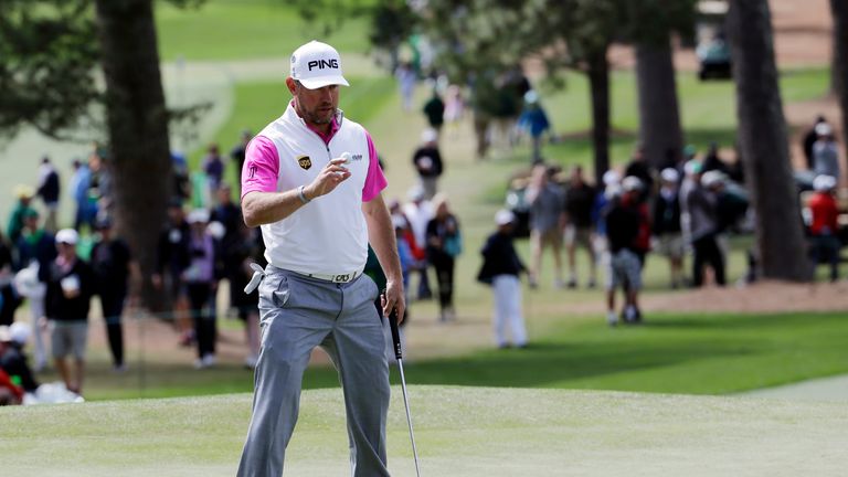 Lee Westwood holds up his ball after a birdie on the seventh hole