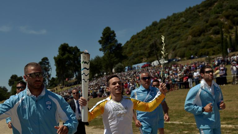 Lefteris Petrounias runs with the Olympic flame at Olympia