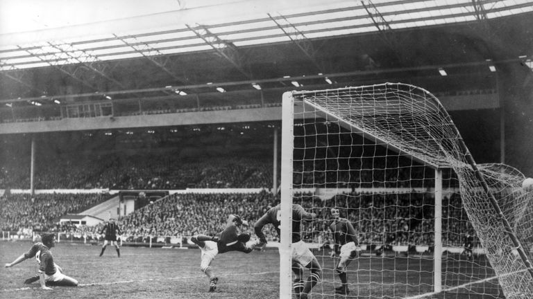 26th April 1969:  Leicester City Football Club goalkeeper Peter Shilton tries in vain to save the winning goal from Manchester City footballer Neil Young i