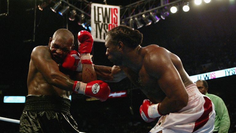 Lennox Lewis hits Mike Tyson with a right hook in the 8th round during their WBC/IBF heavyweight championship bout on June 8, 2002 a