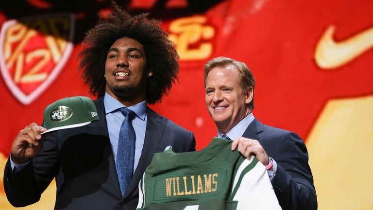 Leonard Williams of the USC Trojans holds up a jersey with NFL Commissioner Roger Goodell after being chosen #6 overall by the New