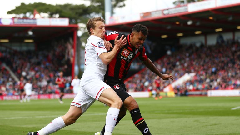 Callum Wilson of Bournemouth holds off pressure from Lucas Leiva of Liverpool 