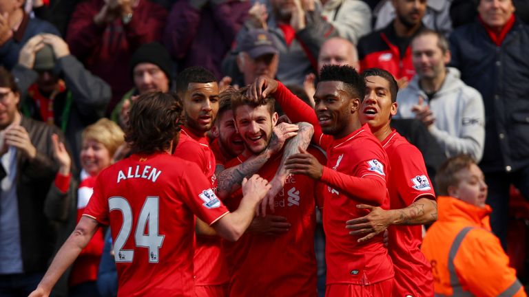 LIVERPOOL, ENGLAND - APRIL 23: Adam Lallana of Liverpool celebrates with team mates after scoring his sides second goal during the Barclays Premier League 